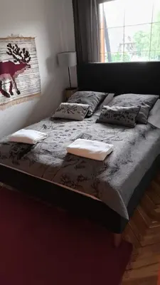 a bed in a bedroom with two pillows on it at Cozy Apartment in Krakow in Kraków