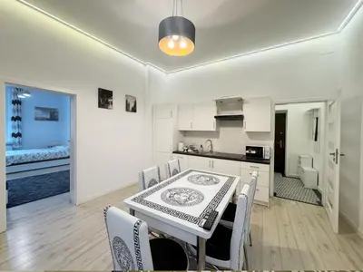 a kitchen and dining room with a table and chairs at White & Black - near Wawel Castle in Kraków