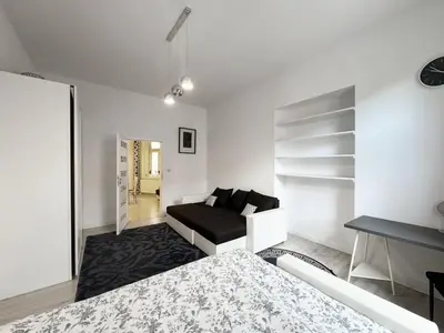 a white room with a bed and a couch at White & Black - near Wawel Castle in Kraków