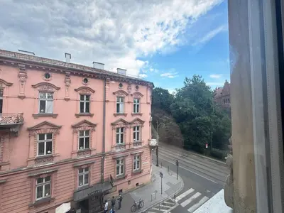 a view from a window of a pink building at White & Black - near Wawel Castle in Kraków
