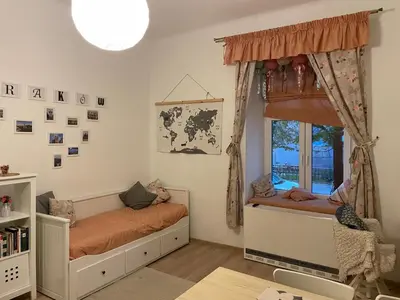 a childs bedroom with a bed and a window at Szlak Home in Kraków
