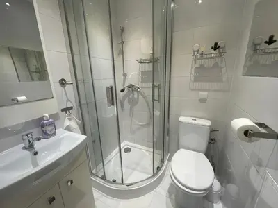 a bathroom with a shower and a toilet and a sink at Szlak Home in Kraków