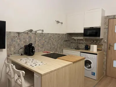 a kitchen with a counter top and a dishwasher at Szlak Home in Kraków