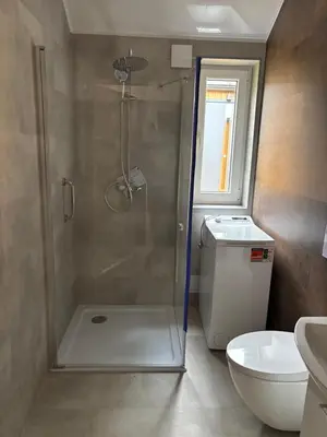 a bathroom with a shower and a toilet at Domki nad Krzyworzeką in Dobczyce