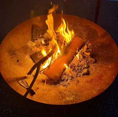 a fire is burning in a pot with flames at Domek na Krakowskiej in Kęty