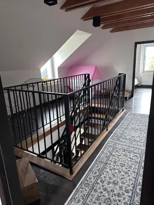 a room with a staircase with a bed in it at Domek na Krakowskiej in Kęty
