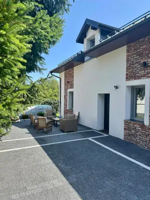 a patio with tables and chairs in front of a house at Domek na Krakowskiej in Kęty