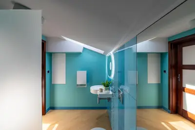 a bathroom with a blue wall and a sink at Dome View Apartment by the Main Square - by Upstairs in Kraków