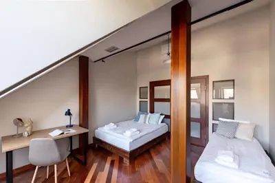 a room with two beds and a desk and a mirror at Dome View Apartment by the Main Square - by Upstairs in Kraków