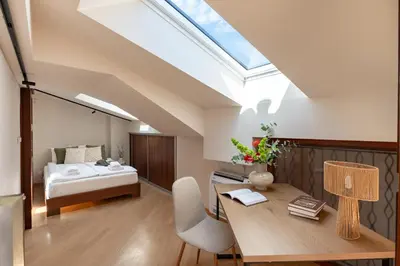 a bedroom with a bed and a desk with a desk at Dome View Apartment by the Main Square - by Upstairs in Kraków