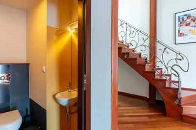 a bathroom with a staircase and a sink at Dome View Apartment by the Main Square - by Upstairs in Kraków