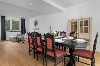 a dining room with a table and chairs at A Unique House with a Terrace and Garden in Cracow for 8 People by Noclegi Renters in Kraków