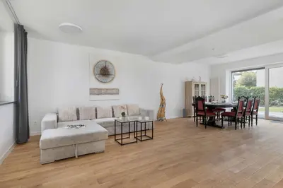 a white living room with a couch and a table at A Unique House with a Terrace and Garden in Cracow for 8 People by Noclegi Renters in Kraków