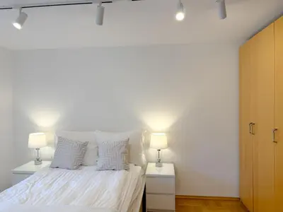 a bedroom with a white bed with two lamps at Fabryczna City Residence 100m2 Balcony by Gio Loft in Kraków