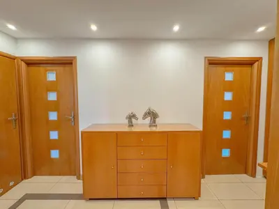 a room with a wooden cabinet and two doors at Fabryczna City Residence 100m2 Balcony by Gio Loft in Kraków