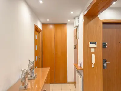 a bathroom with a wooden door and a sink at Fabryczna City Residence 100m2 Balcony by Gio Loft in Kraków
