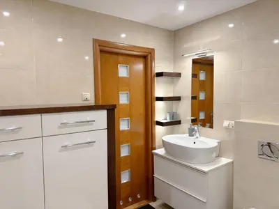 a bathroom with a white sink and a mirror at Fabryczna City Residence 100m2 Balcony by Gio Loft in Kraków