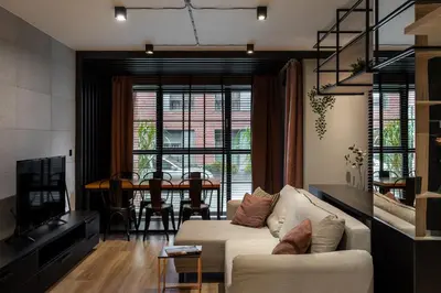 a living room with a couch and a dining room at Kraków Wawrzyńca Suites by Downtown Apartments in Kraków
