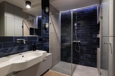 a bathroom with a sink and a shower at Kraków Wawrzyńca Suites by Downtown Apartments in Kraków
