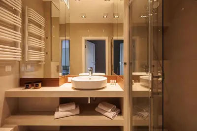 a bathroom with a sink and a mirror at City of the Kings - Solaris Apartment in Kraków