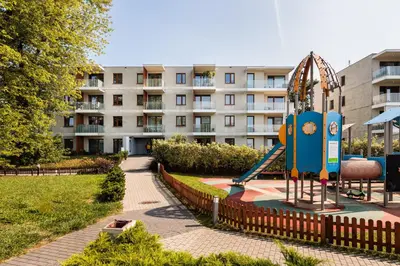 a playground in a park in front of a building at City of the Kings - Solaris Apartment in Kraków