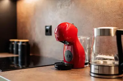 a red mixer sitting on top of a counter at City of the Kings - Eden Apartment in Kraków