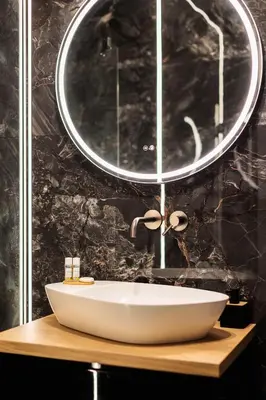 a bathroom with a white sink and a mirror at City of the Kings - Eden Apartment in Kraków