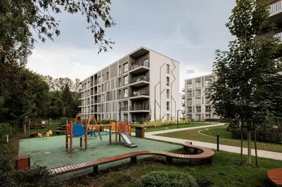 an apartment building with a playground in front of it at City of the Kings - Eden Apartment in Kraków