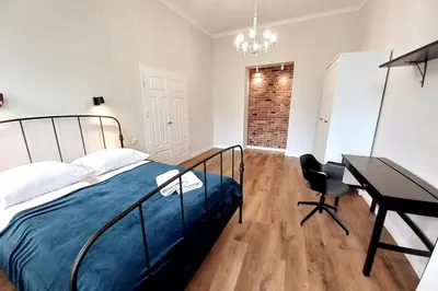 a bedroom with a bed and a desk and a piano at Krakowska Street Old Town Apt 16 in Kraków