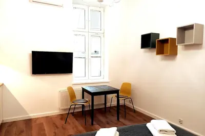 a room with a table and chairs and a window at Krakowska Street Old Town Apt 16a in Kraków