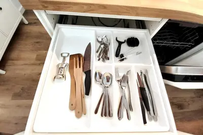 a drawer full of kitchen utensils in a cabinet at Krakowska Street Old Town Apt 16a in Kraków