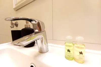 a bathroom sink with two bottles of soap on it at Krakowska Street Old Town Apt 16a in Kraków