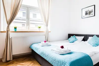 two twin beds in a room with a window at 3D Royal Castle Apartament in Kraków