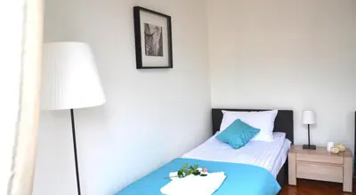 a bedroom with a bed and a lamp at 3D Royal Castle Apartament in Kraków