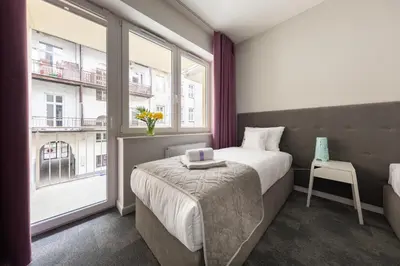 a hotel room with a bed and a window at PlayRoom Aparthotel in Kraków