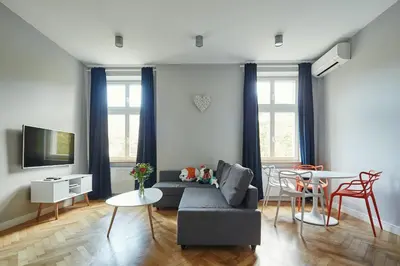 a living room with a couch and a table at PlayRoom Aparthotel in Kraków