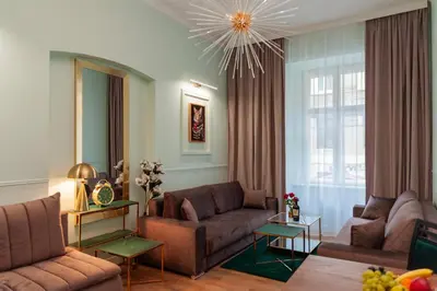 a living room with two couches and a chandelier at Apartament Aria in Kraków