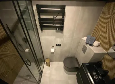 a small bathroom with a shower and a toilet at Apartament Aria in Kraków