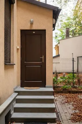 a black door on the side of a house at Apartament Aria in Kraków