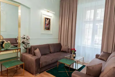 a living room with a couch and a table at Apartament Aria in Kraków