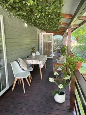 a patio with a table and chairs on a deck at Korzkiewka in Korzkiew