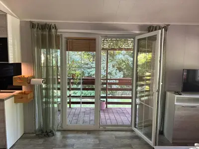 an open door to a patio with sliding glass doors at Korzkiewka in Korzkiew