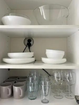 a shelf with plates and dishes and glasses at Main Square Apartment- Tomasza Street in Kraków