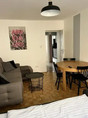 a living room with a couch and a table at Main Square Apartment- Tomasza Street in Kraków