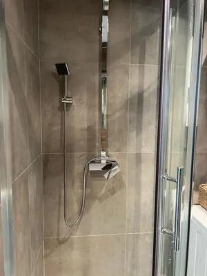 a shower with a shower head in a bathroom at Main Square Apartment- Tomasza Street in Kraków