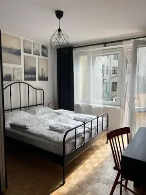 a bedroom with a bed and a window at Main Square Apartment- Tomasza Street in Kraków