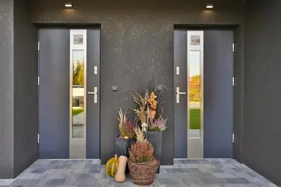 a front door of a building with pumpkins and plants at Sun & Garden House in Oświęcim