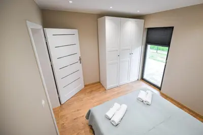 a bedroom with a bed with two towels on it at Sun & Garden House in Oświęcim