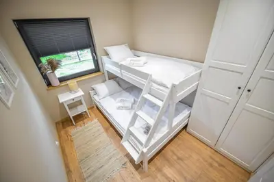 a small room with a bunk bed and a window at Sun & Garden House in Oświęcim