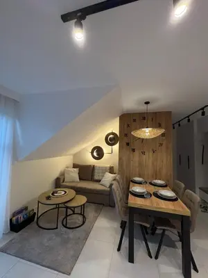 a living room with a table and a couch at Babia Perła Zawoja in Zawoja
